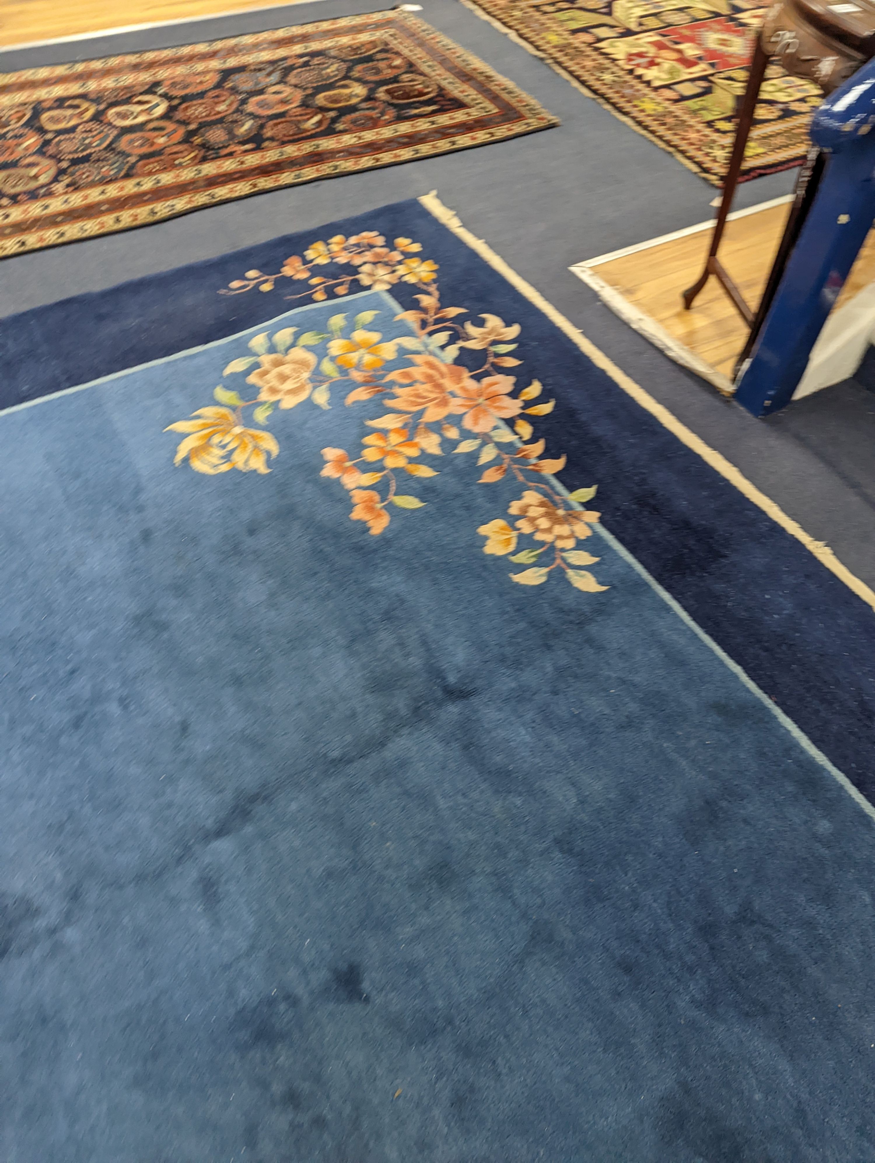 An early 20th century Art Deco Chinese blue ground floral carpet, 400 x 310cm